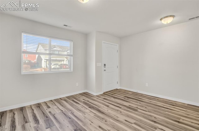 empty room with light hardwood / wood-style flooring