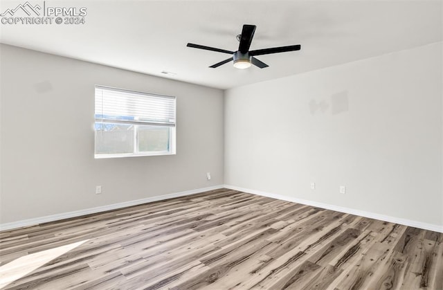 spare room with ceiling fan and light hardwood / wood-style floors