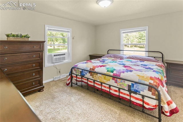 bedroom featuring light carpet, multiple windows, cooling unit, and baseboards