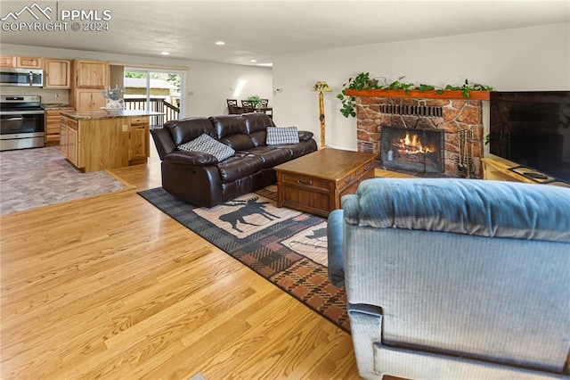 living room with a fireplace and light hardwood / wood-style floors