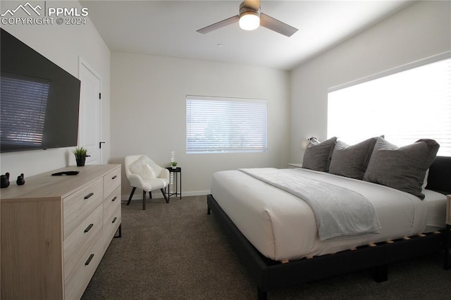 bedroom with ceiling fan and dark colored carpet