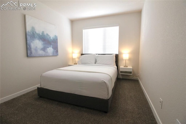 bedroom featuring dark colored carpet