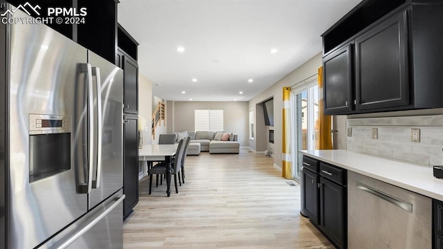 kitchen with backsplash, stainless steel fridge with ice dispenser, and light hardwood / wood-style floors