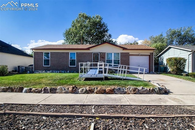 single story home featuring a garage and a front yard