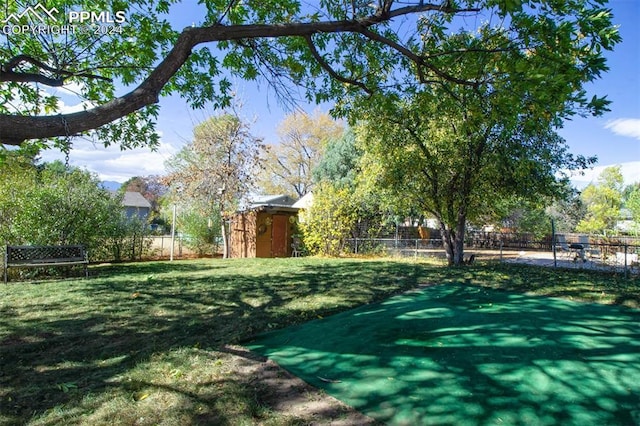 surrounding community with a yard and a storage shed