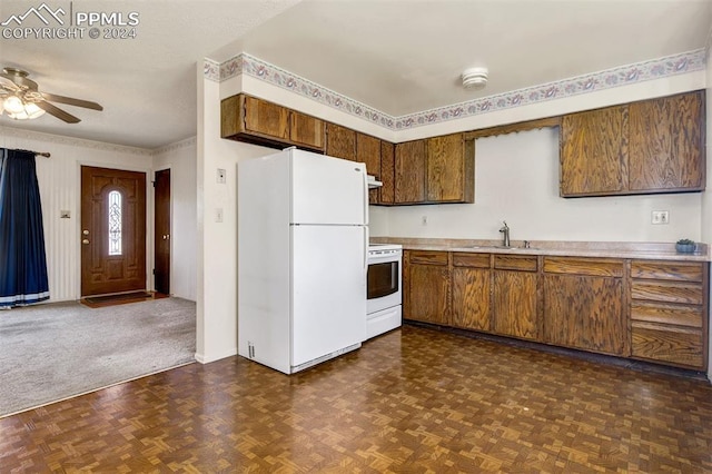 kitchen featuring ceiling fan, sink, dark parquet floors, and white appliances