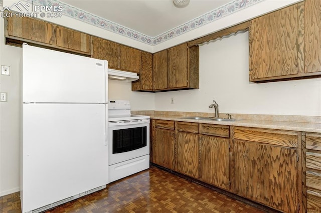 kitchen featuring dark parquet flooring, sink, and white appliances