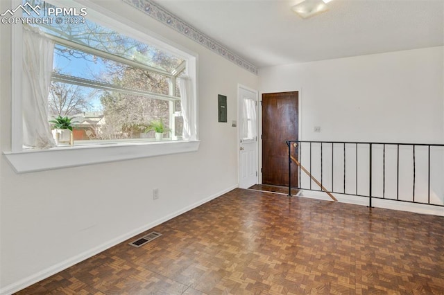 empty room with dark parquet floors