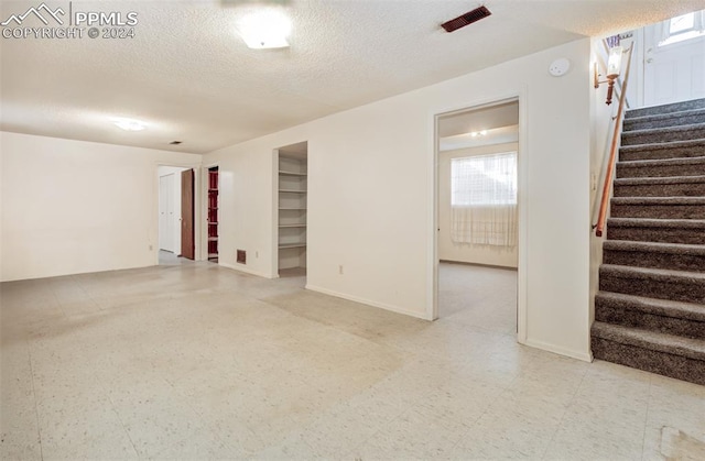 empty room featuring a textured ceiling