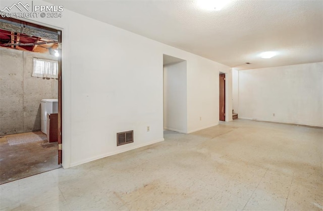 unfurnished room with a textured ceiling