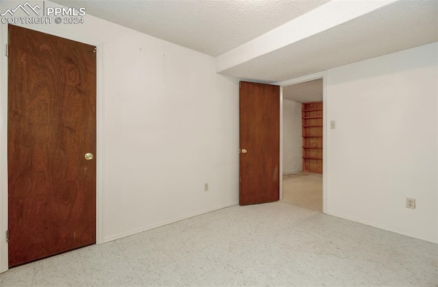 spare room featuring a textured ceiling