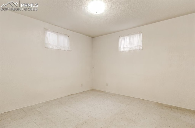 basement featuring a textured ceiling