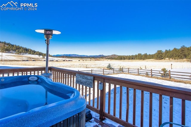 deck with a mountain view, a rural view, and a hot tub