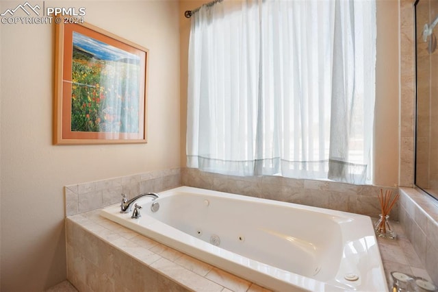 bathroom with a relaxing tiled tub