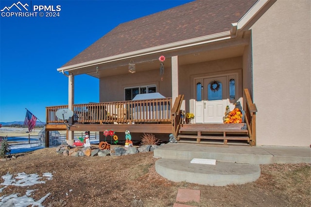 view of exterior entry with a porch