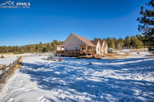 view of snow covered rear of property