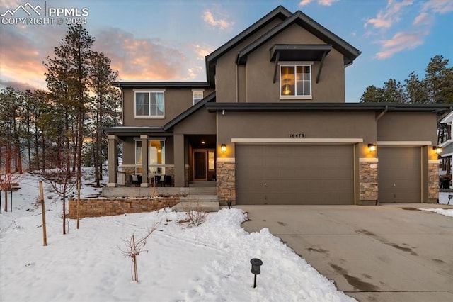 view of front of home featuring a porch and a garage