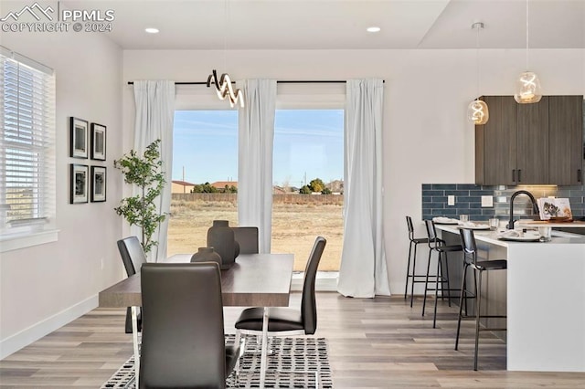 dining area featuring light hardwood / wood-style flooring and sink