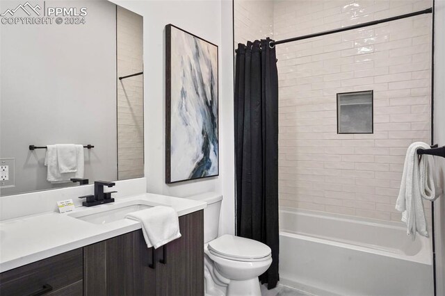 full bathroom with vanity, shower / bath combination with curtain, and toilet