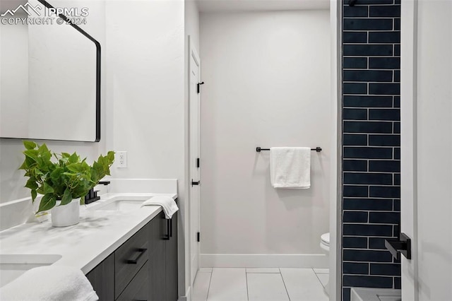 bathroom with tile patterned floors, vanity, and toilet