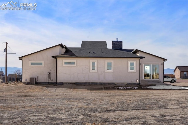 rear view of house with cooling unit