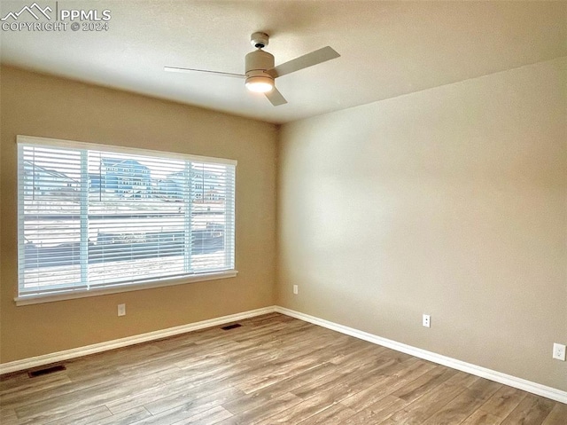 unfurnished room with ceiling fan and light hardwood / wood-style floors