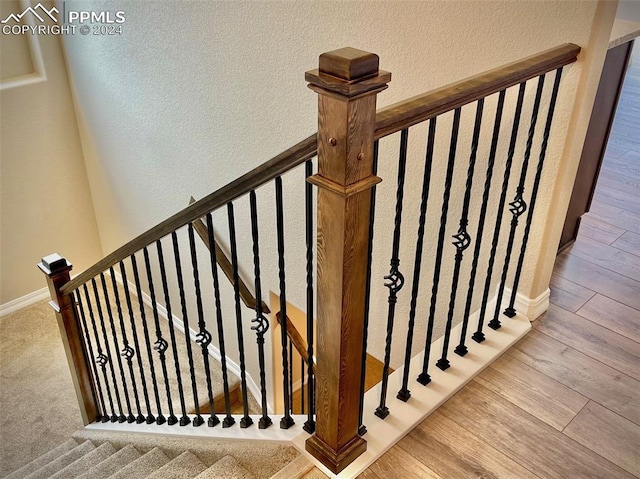 staircase featuring hardwood / wood-style floors