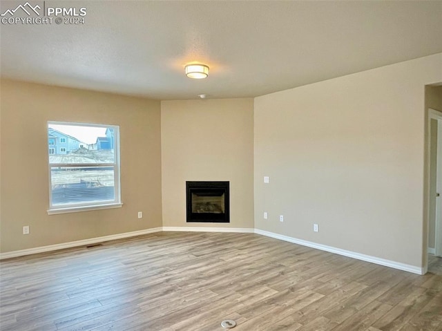 unfurnished living room featuring light hardwood / wood-style flooring