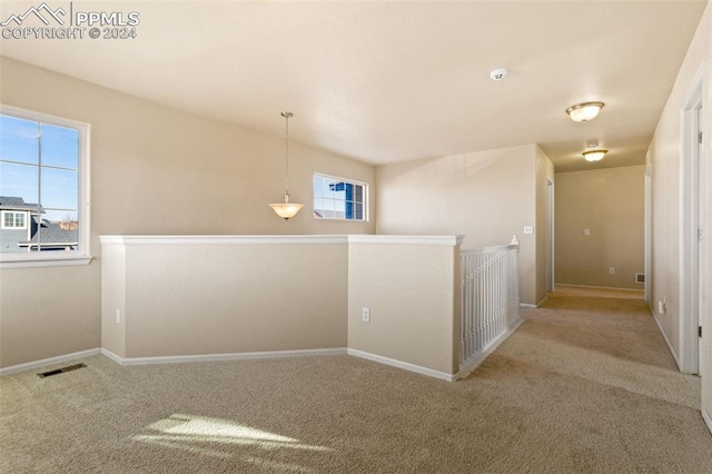 hallway featuring carpet and a healthy amount of sunlight