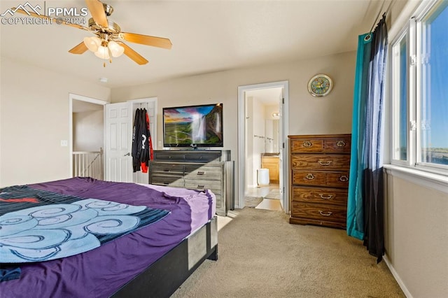 carpeted bedroom with connected bathroom and ceiling fan