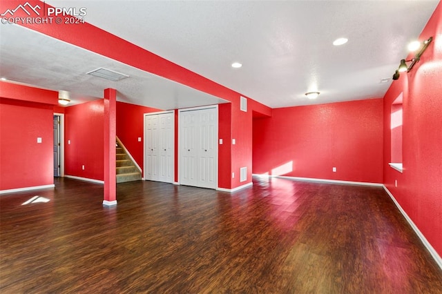 unfurnished room with dark hardwood / wood-style flooring