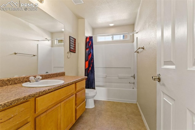 full bathroom with tile patterned flooring, a textured ceiling, toilet, shower / tub combo with curtain, and vanity