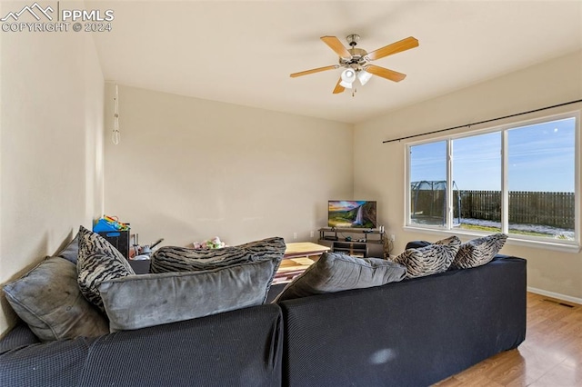 living room featuring light hardwood / wood-style flooring and ceiling fan