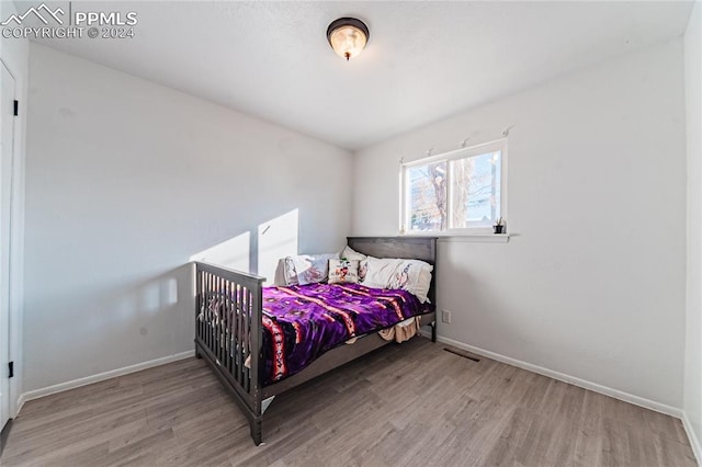 bedroom with light hardwood / wood-style flooring