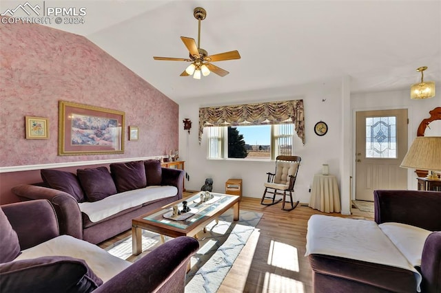 living room featuring a wealth of natural light, ceiling fan, lofted ceiling, and light wood-type flooring