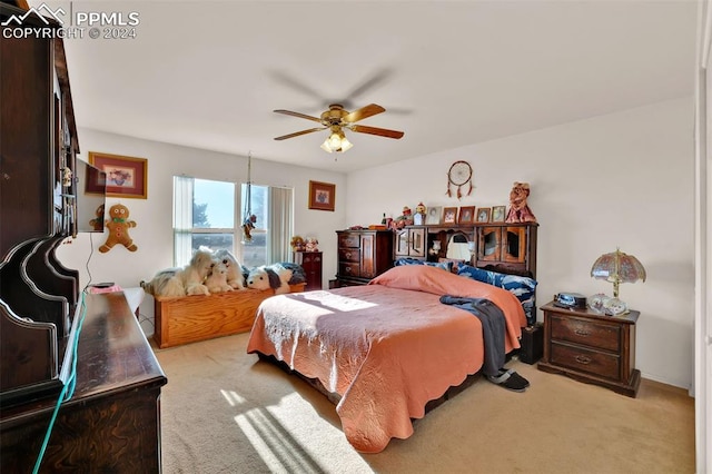 bedroom featuring ceiling fan and light carpet