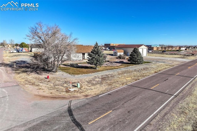 view of front of property featuring a garage and an outbuilding