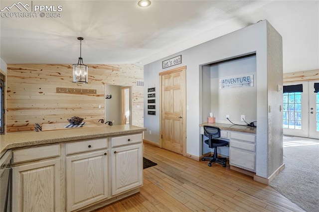 kitchen featuring wood walls, french doors, hanging light fixtures, light hardwood / wood-style flooring, and vaulted ceiling