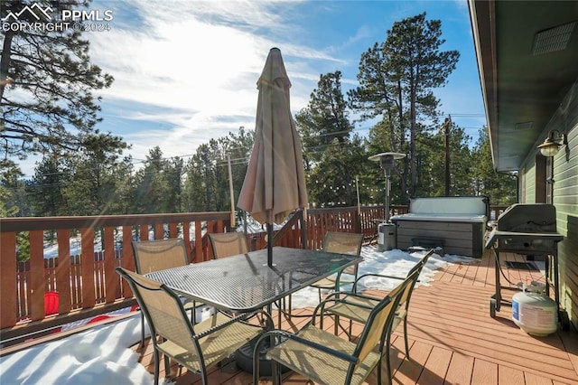 wooden deck with a grill and a hot tub