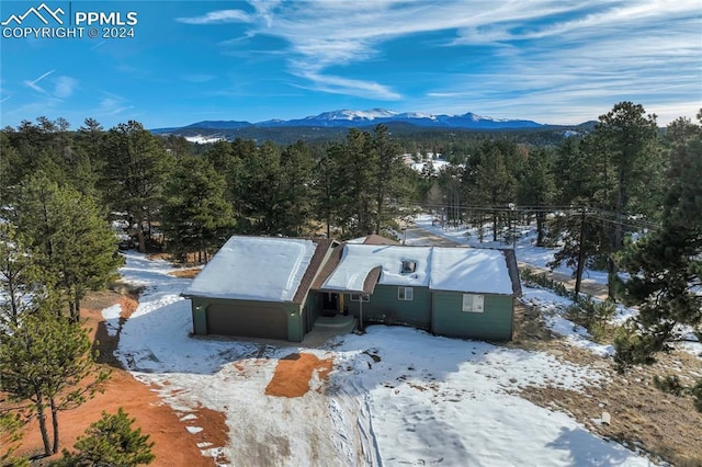 snowy aerial view featuring a mountain view