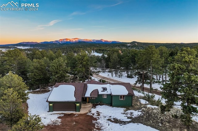 snowy aerial view featuring a mountain view