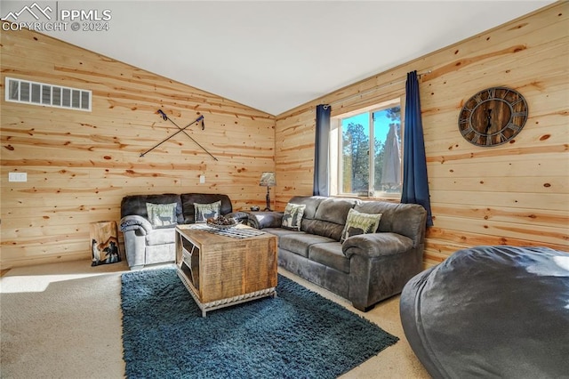 living room featuring wooden walls, carpet, and vaulted ceiling