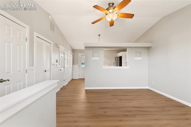 interior space featuring hardwood / wood-style floors, ceiling fan, and lofted ceiling