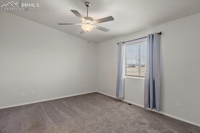 spare room featuring carpet floors and ceiling fan