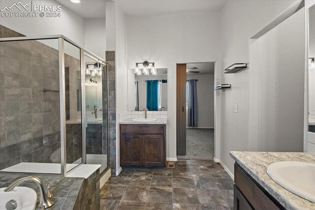 bathroom featuring vanity and a shower with shower door