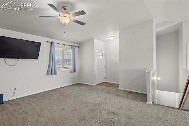 unfurnished living room featuring carpet flooring and ceiling fan