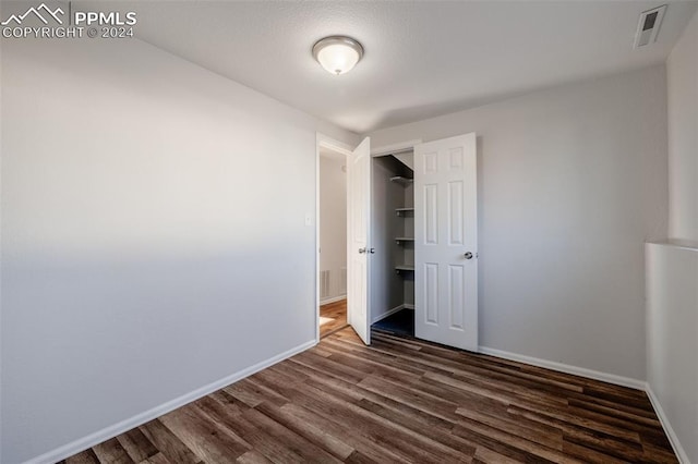 unfurnished bedroom featuring dark hardwood / wood-style flooring