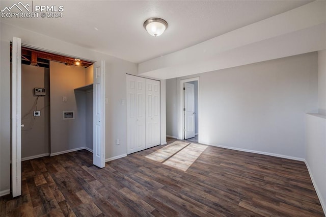 unfurnished bedroom with dark hardwood / wood-style flooring