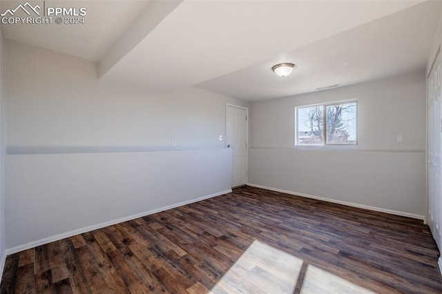 spare room with dark hardwood / wood-style flooring