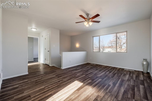 empty room featuring ceiling fan and dark hardwood / wood-style floors